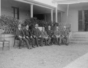 James Robinson and distinguished friends dressed up and sitting in front of Kimo Homestead