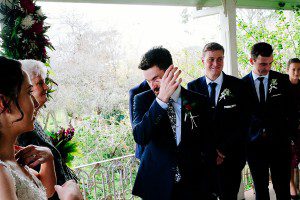 groom in tears at a wedding ceremony on a wet day at Kimo Estate ceremony