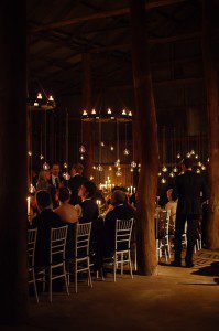 guests in moody shed in black tie at a country wedding