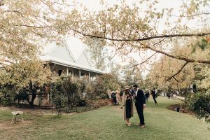 A stunning country homestead with wedding guests at a ceremony in NSW