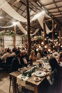 Rustic wedding venue on a farm in NSW, Guests enjoying the wedding reception in an old barn