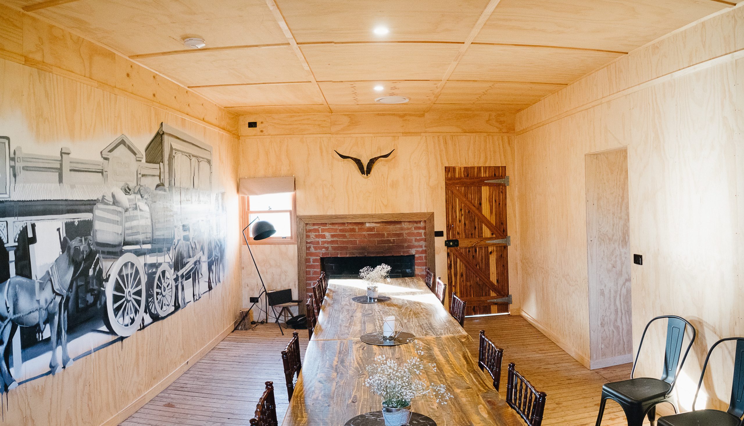 historic mural on the wall of the shearers quarters at Kimo Estate, fireplace with wood fire and central heating