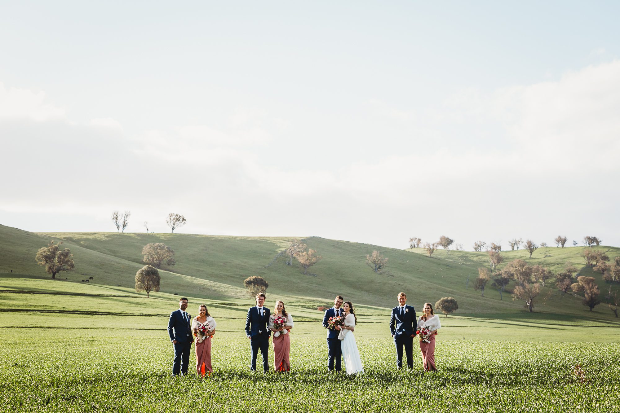 bridal party standing in green pasture at kimo estate wedding venue