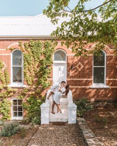 couple in front of beautiful historic building embracing and smiling 4