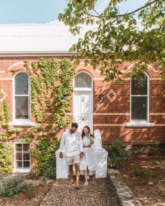 couple in front of beautiful historic building embracing and smiling 2