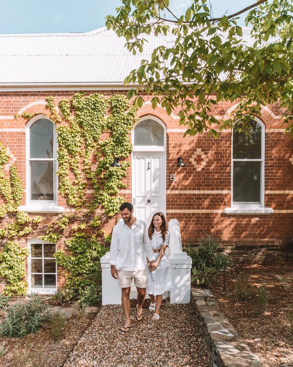 couple in front of beautiful historic building embracing and smiling 1