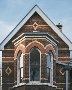 Historic facade and bay windows of historic red brick hotel