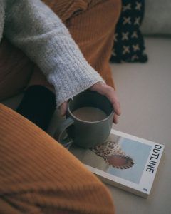 lady drinking coffee with a book