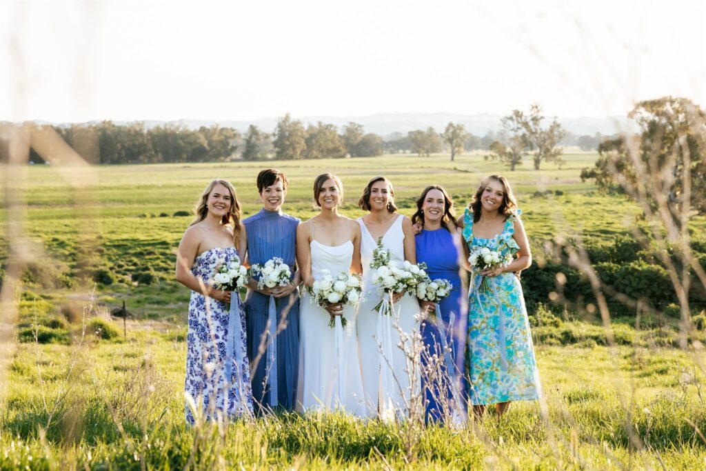 Brides and their bridesmaids at Kimo Estate with the river flats in the background