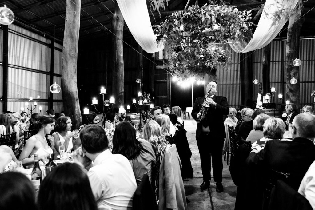 A saxophonist playing at a wedding reception 