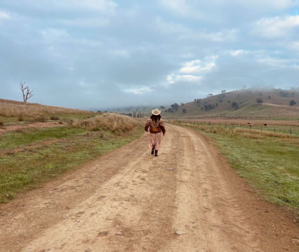 girl waling down a dirt road on a walking track