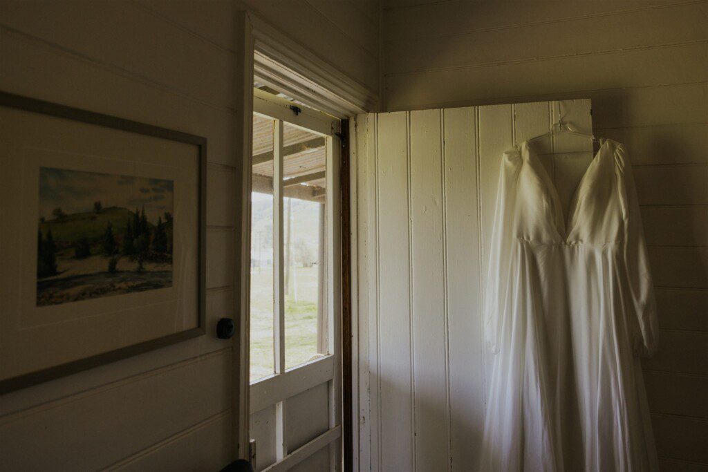 Wedding dress hanging in accommodation