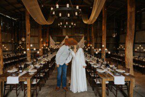 A couple kissing in the barn Wedding venue.